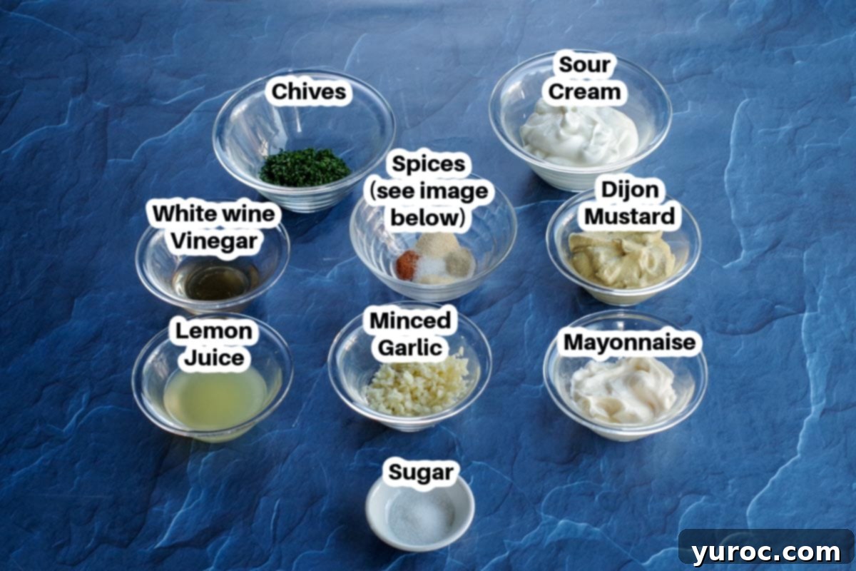 All the individual ingredients for the sweet potato fries dip laid out in glass bowls on a blue surface, clearly labeled.