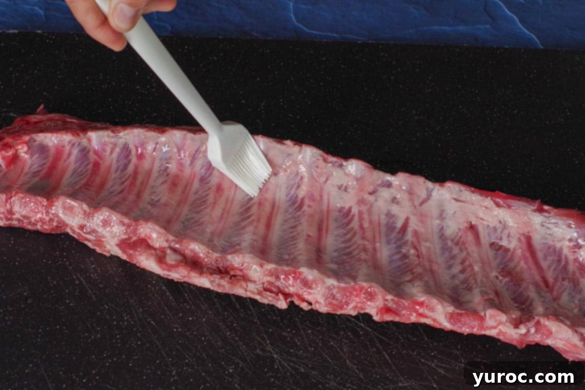 Ribs being brushed with olive oil