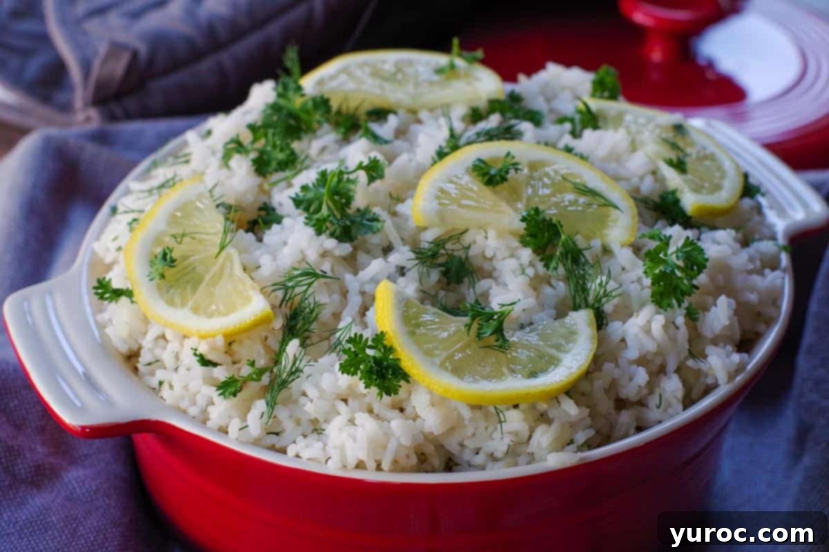 Greek rice with lemon and herb garnish in orange dish