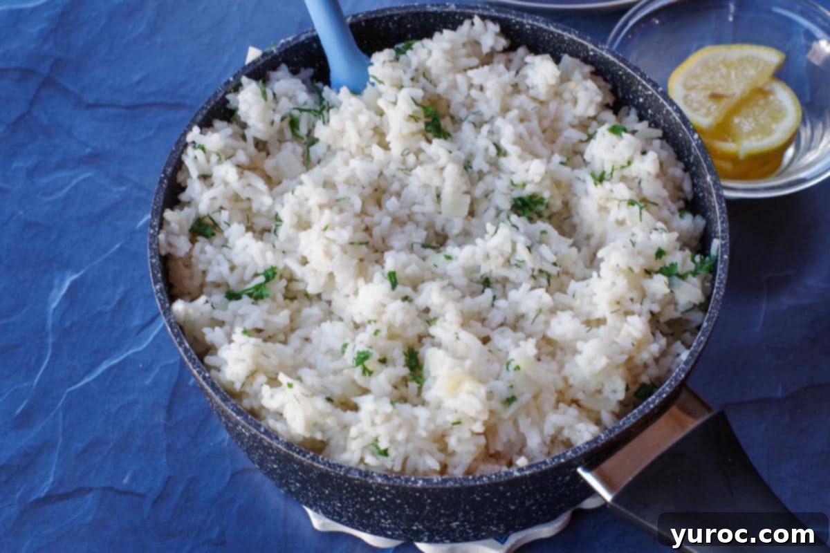 cooked rice in black pot with herbs