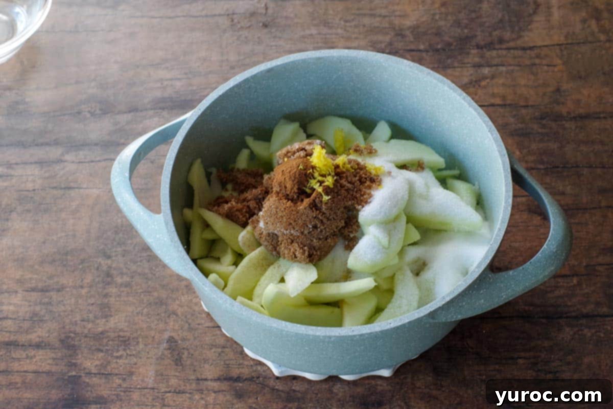 apple, cinnamon, sugars, lemon zest added to butter in blue pot