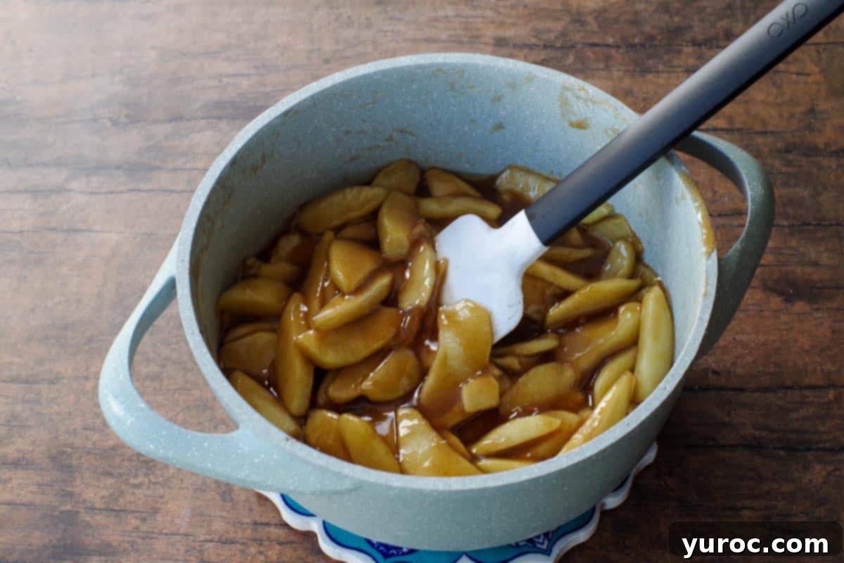 apple filling (thickened) in blue pot with spatula