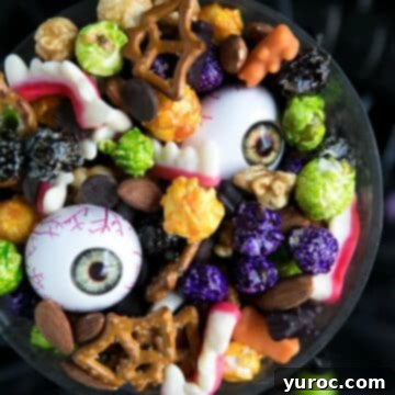 Halloween party mix (with plastic eyeballs) in a black bowl