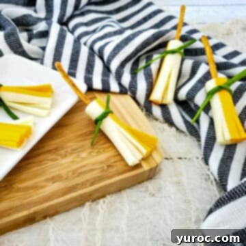 witches broom snacks on a cutting board and on top of navy and white striped linen