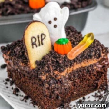 Halloween dirt cake with ghost and tombstone and gummy worm on white plate