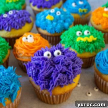 Monster cupcakes lined up beside each other