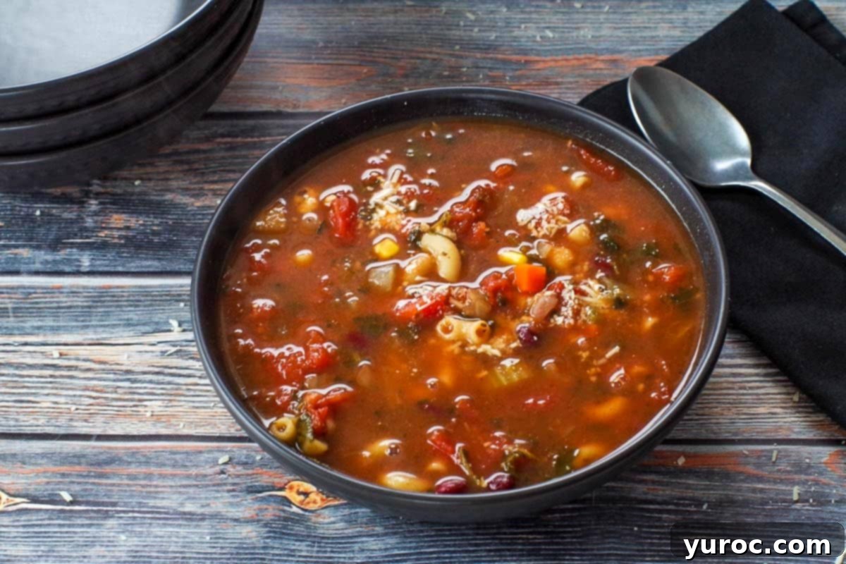 Wholesome Minestrone Made Easy 1 A steaming bowl of vibrant minestrone soup, rich with vegetables and pasta, garnished with fresh herbs and a sprinkle of Parmesan cheese, ready to be enjoyed.