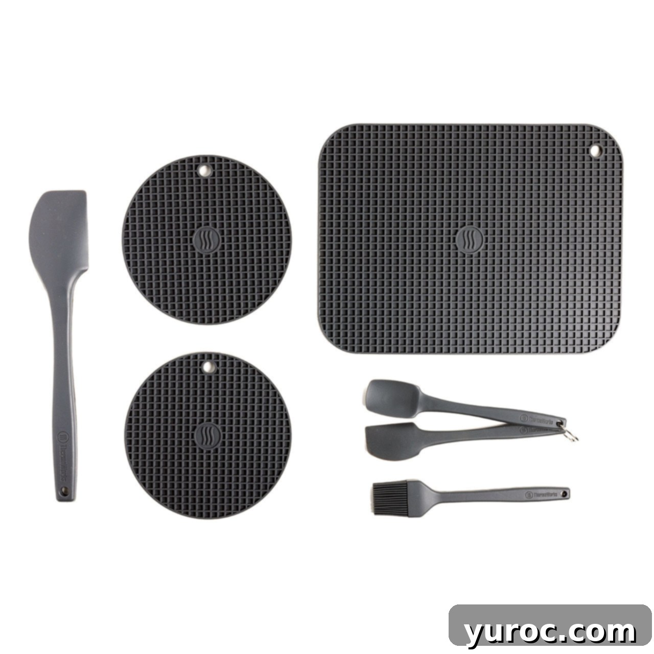 Wholesome Minestrone Made Easy 7 A collection of high-temperature silicone kitchen tools, including a large mat, two trivets, spatulas, and a brush, all in black, suitable for various cooking tasks.