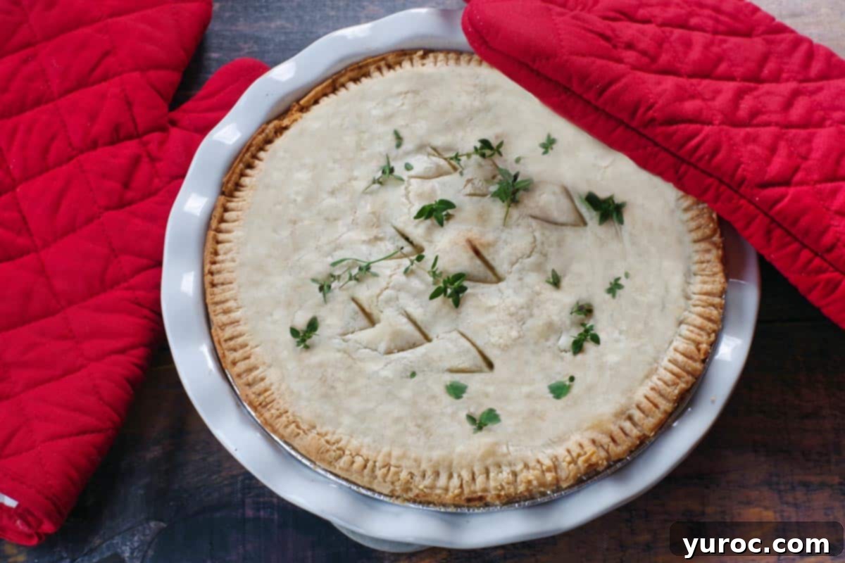 Whole turkey pot pie with red oven mitts