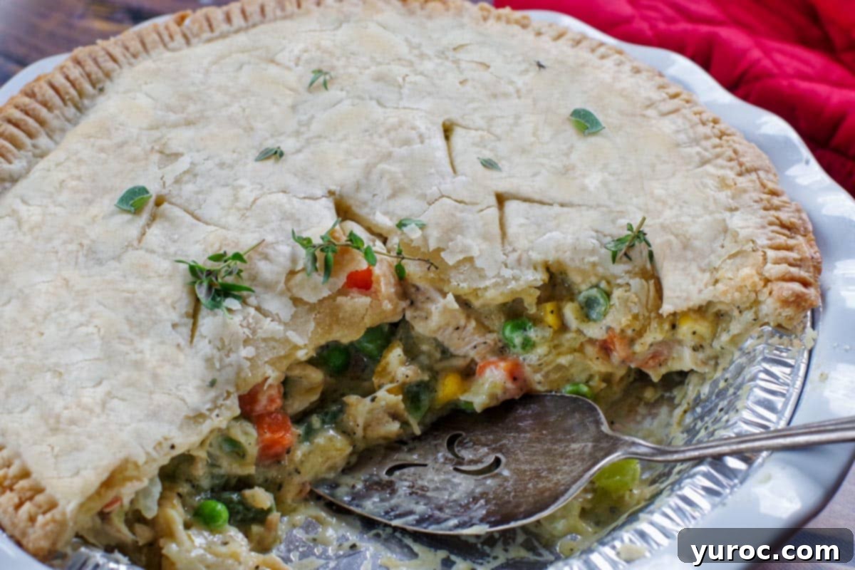 Half a turkey pot pie with a pie lifter in the pan