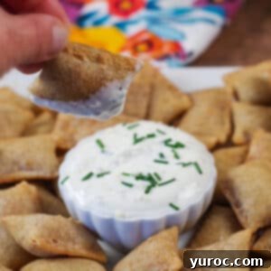Air Fryer Pizza Bite being dipped over a tray of more Air Fryer Pizza Bites.