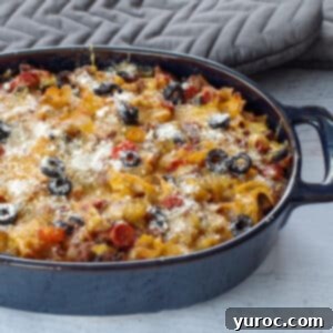 Guilt Free Pizza Casserole 12 healthy pizza casserole in a blue casserole dish with grey oven mitts in the background