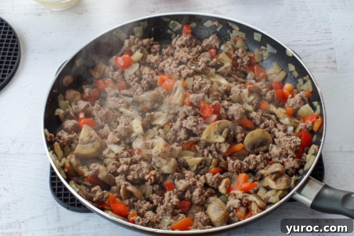 Guilt Free Pizza Casserole 5 browned ground beef with vegetables in skillet