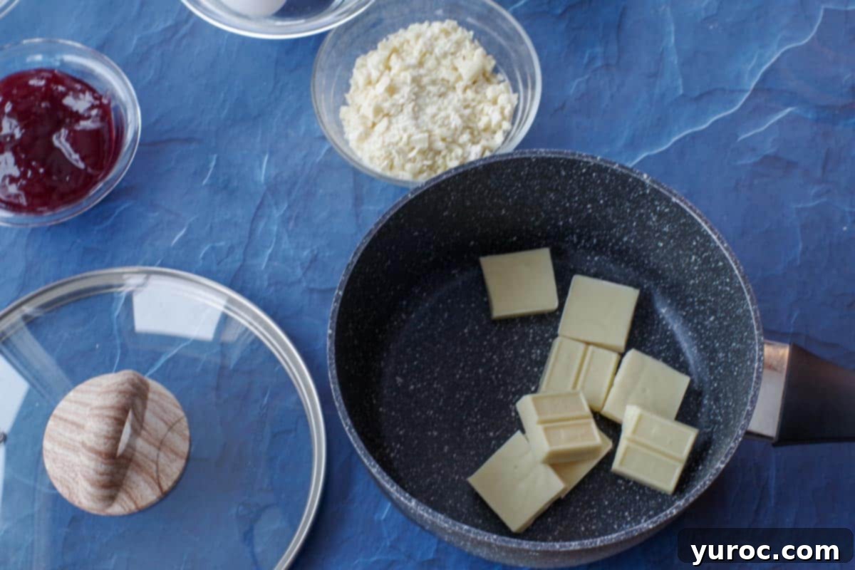 baker's white chocolate pieces in a pot with dish of chopped white chocolate in background