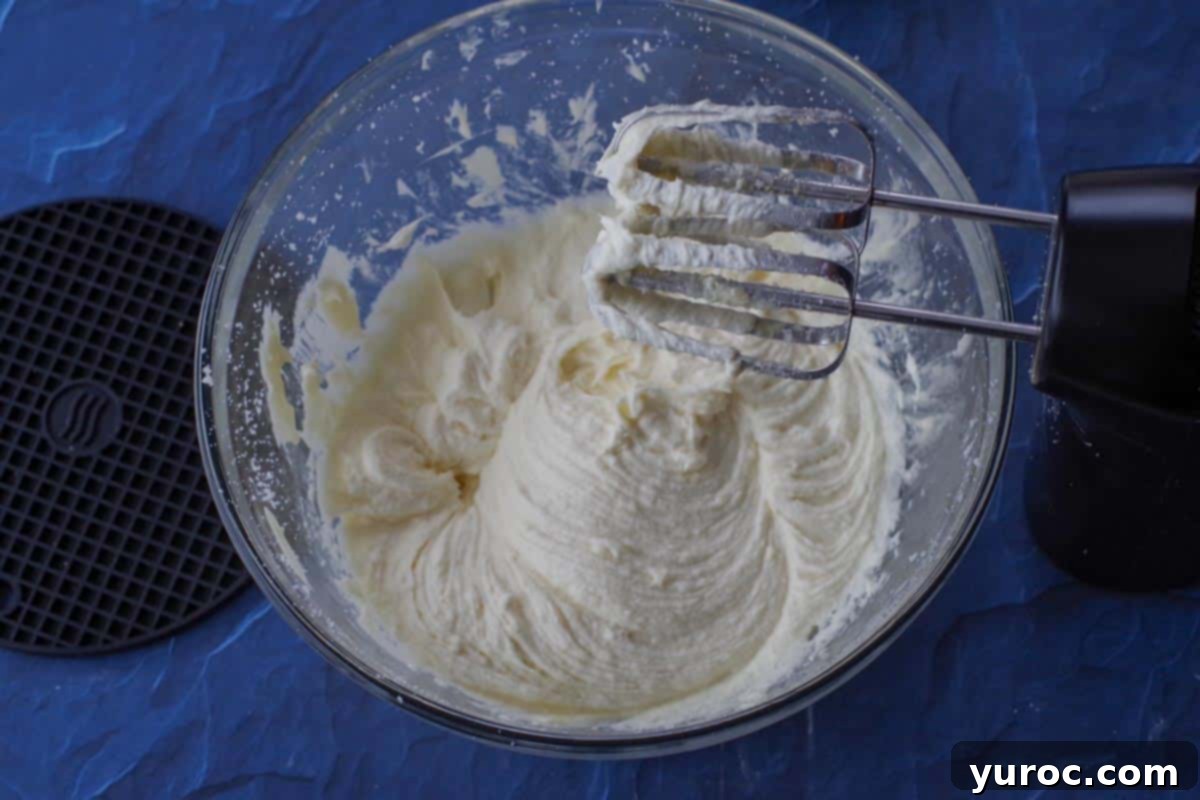 eggs and melted baking bar added to batter in glass bowl with electric mixer