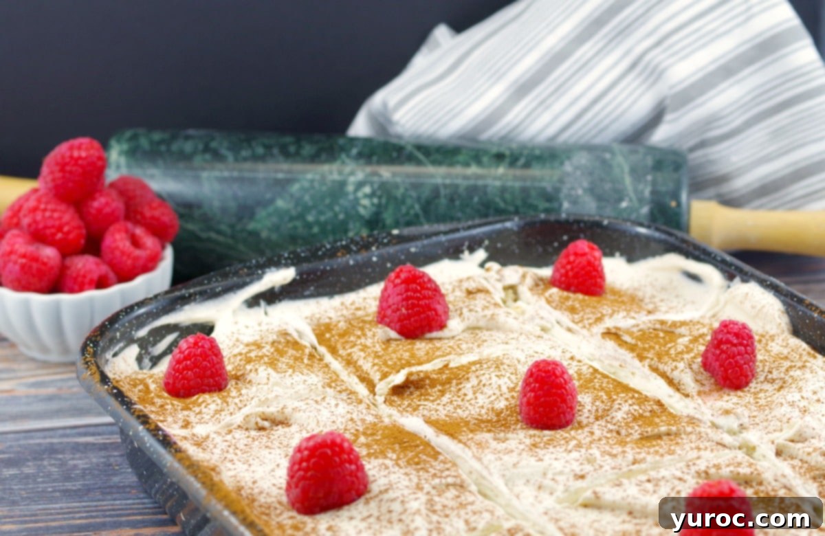 A close-up shot of a beautifully assembled Cinnamon Roll Breakfast Lasagna, showcasing its delicious layers and perfect for a breakfast potluck.