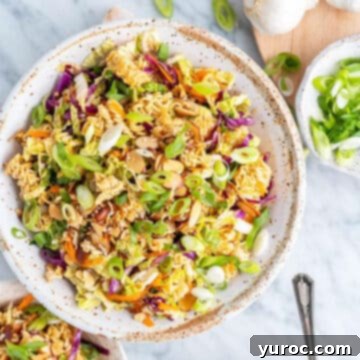 ramen noodle salad in a white bowl with beige rim