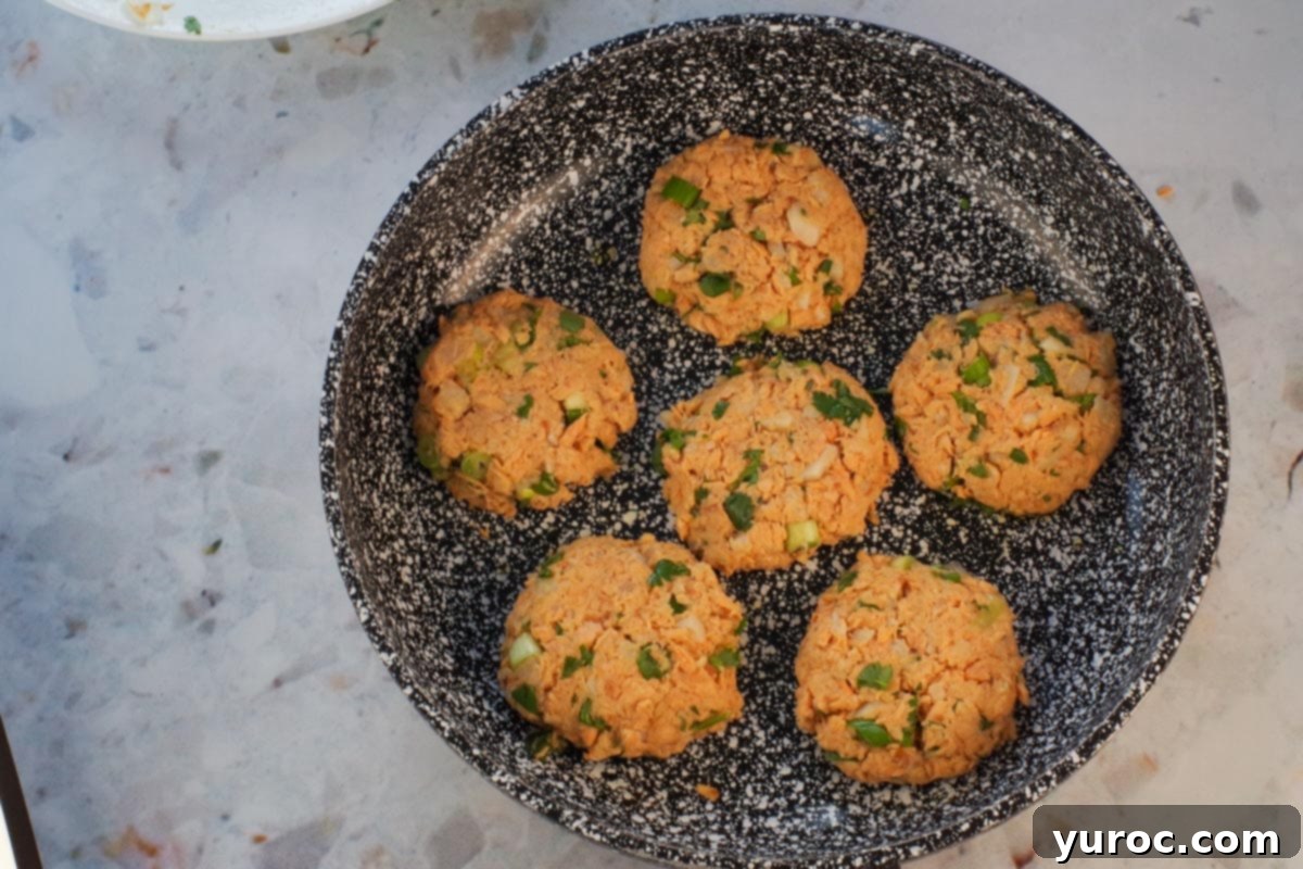Golden Salmon Cakes with Zesty Ginger Lime Cream 6 6 salmon patties in frying pan (uncooked).