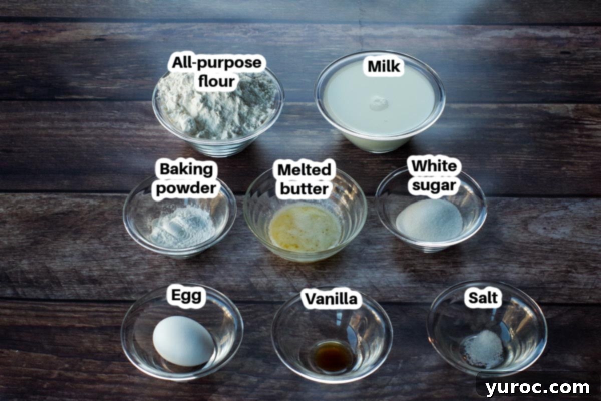 Individual glass bowls containing the key ingredients for old-fashioned pancakes: white sugar, a single egg, a bowl of milk, and a small dish of melted butter, all neatly labeled.