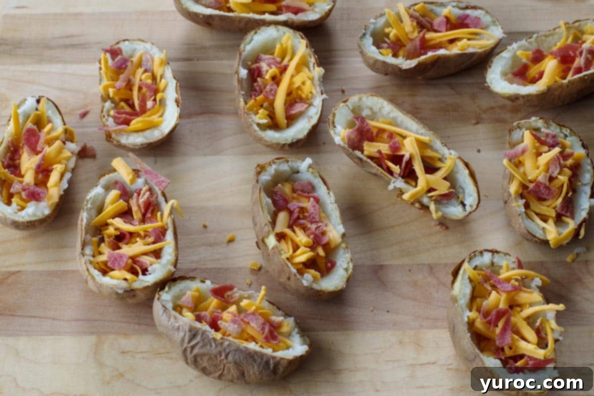 potato skins with cheese and bacon on wooden cutting board