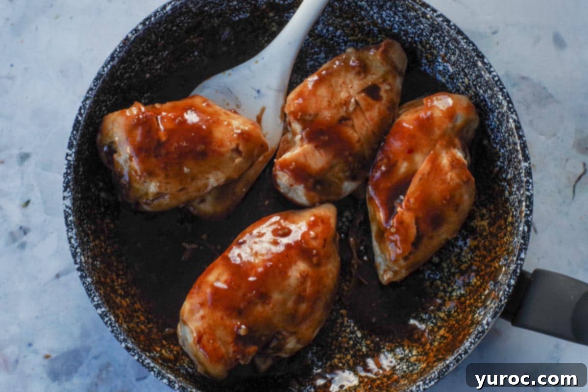Sticky Orange Hoisin Chicken 11 Cooked chicken returned to the skillet, coated in the rich, thickened orange hoisin sauce