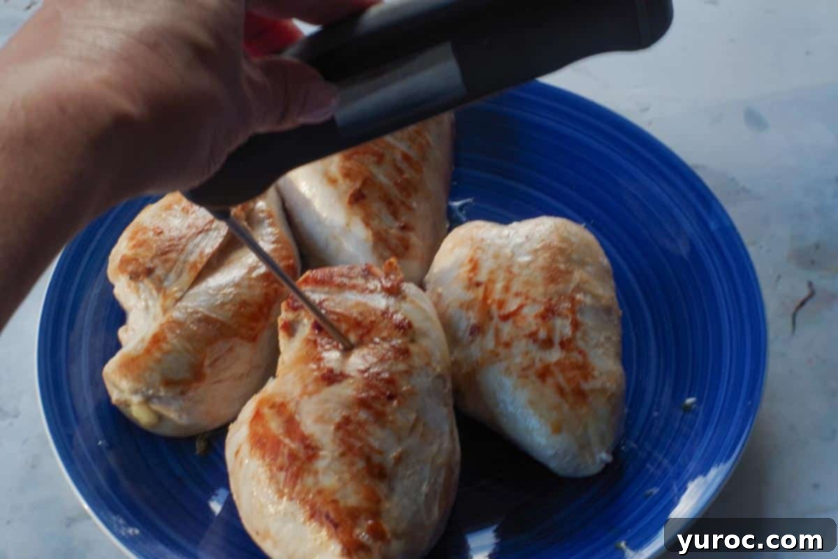 Sticky Orange Hoisin Chicken 6 Perfectly cooked chicken breast on a blue plate, with a digital meat thermometer verifying temperature