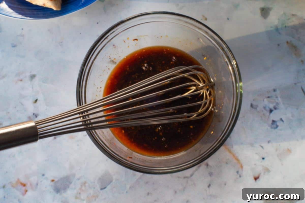 Sticky Orange Hoisin Chicken 7 Ingredients for the orange hoisin sauce combined in a glass bowl, ready to be whisked