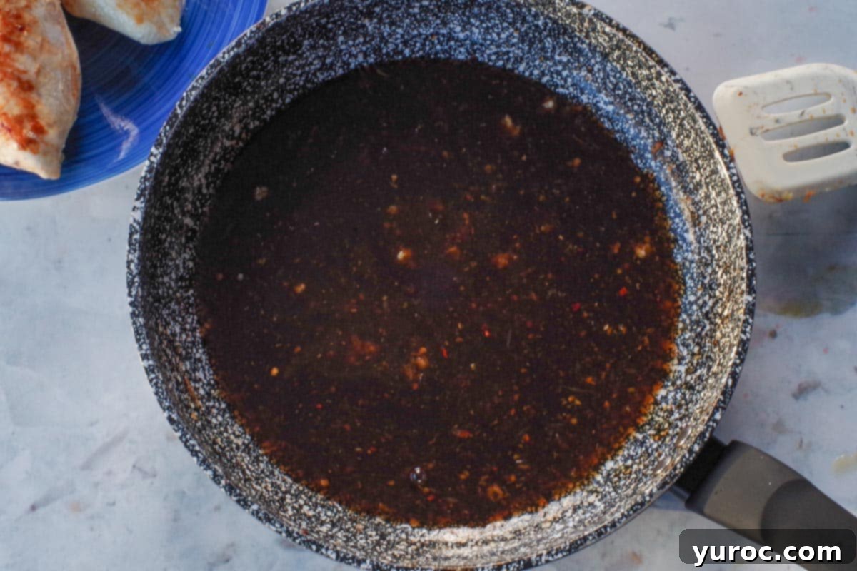 Sticky Orange Hoisin Chicken 9 Orange hoisin sauce mixture poured into the hot skillet with sautéed garlic