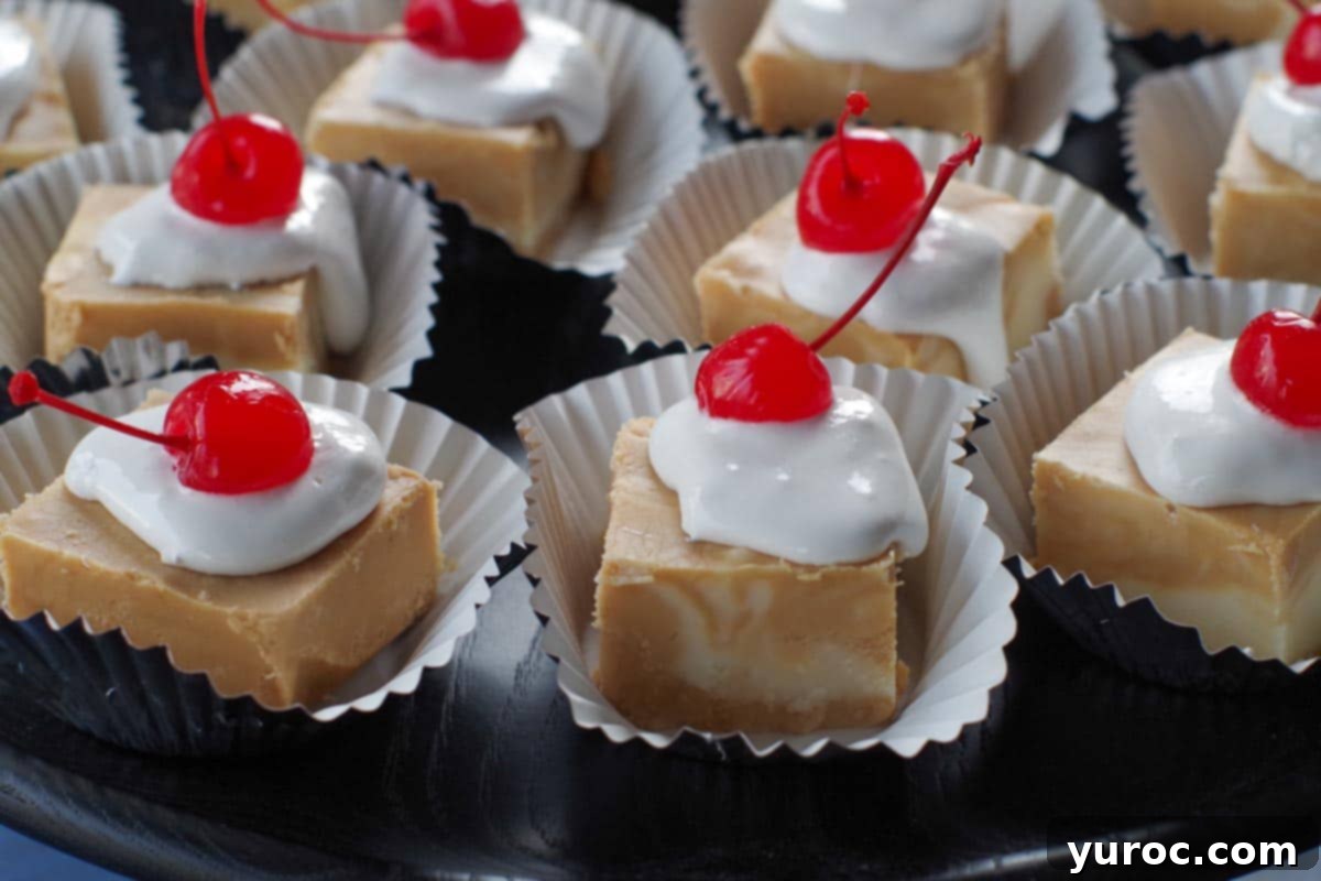 pieces of root beer float fudge on cupcake liners, on a black try