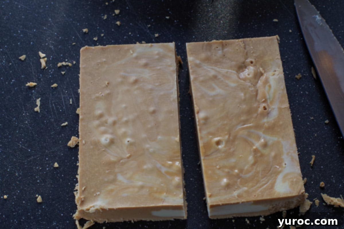 fudge cut in half on black cutting board