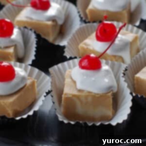 pieces of root beer float fudge on cupcake liners, on a black tray
