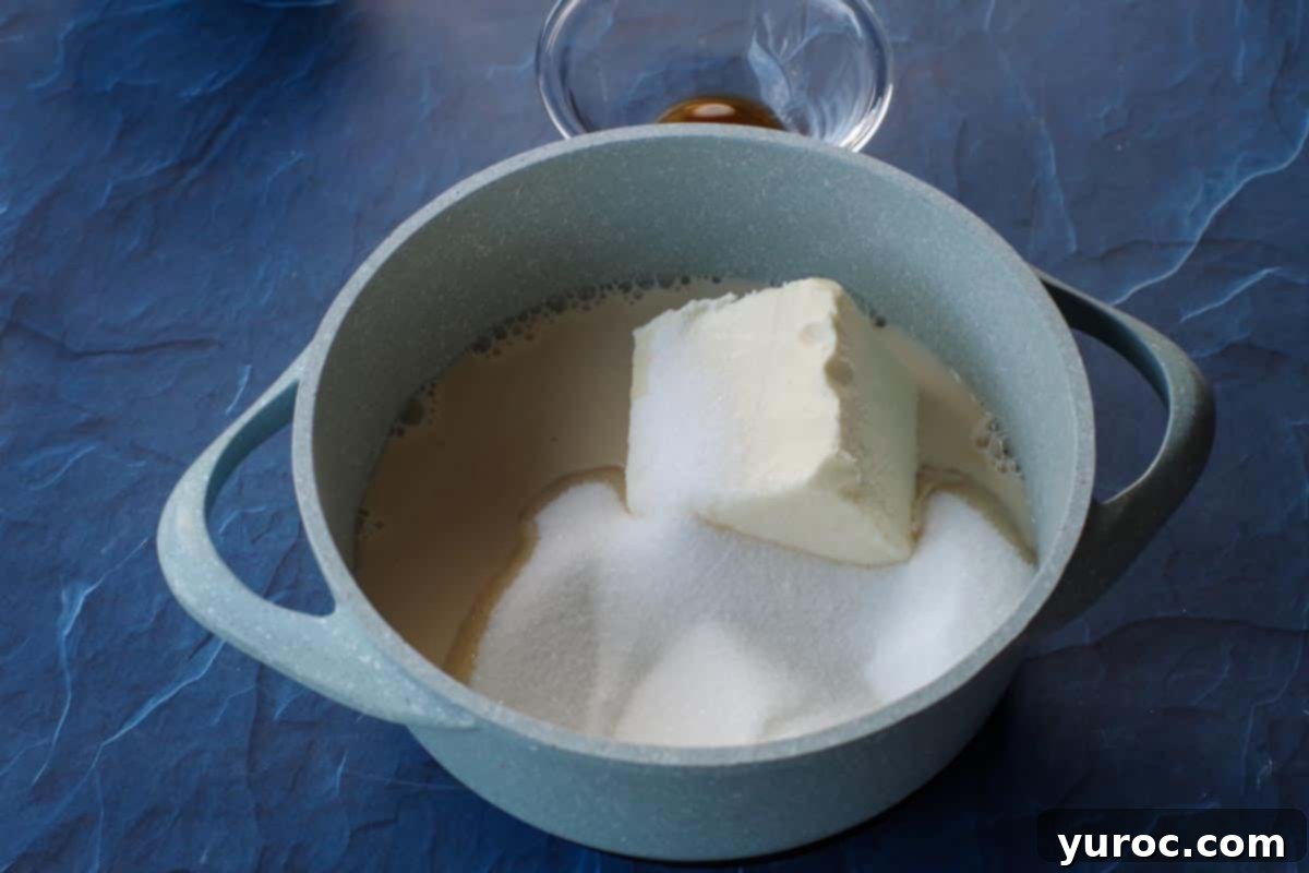 sugar milk and butter in a light blue saucepan