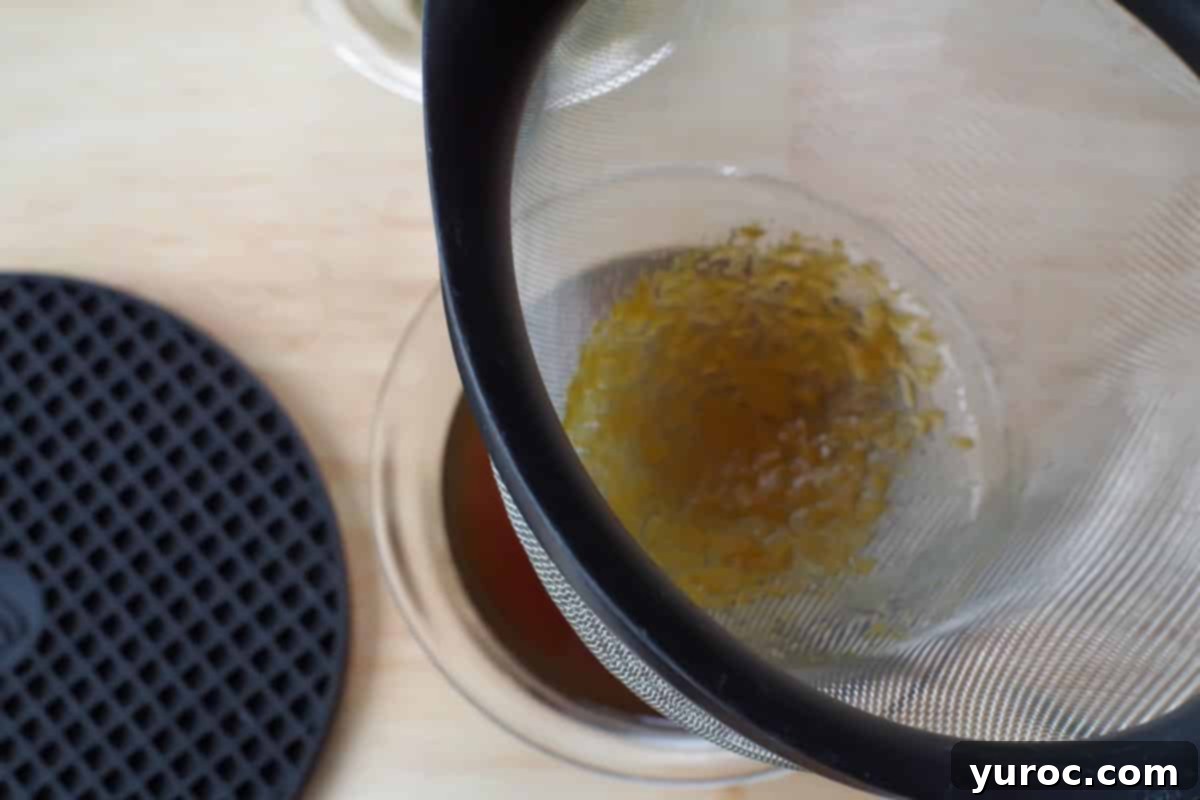 sauce being strained through sieve