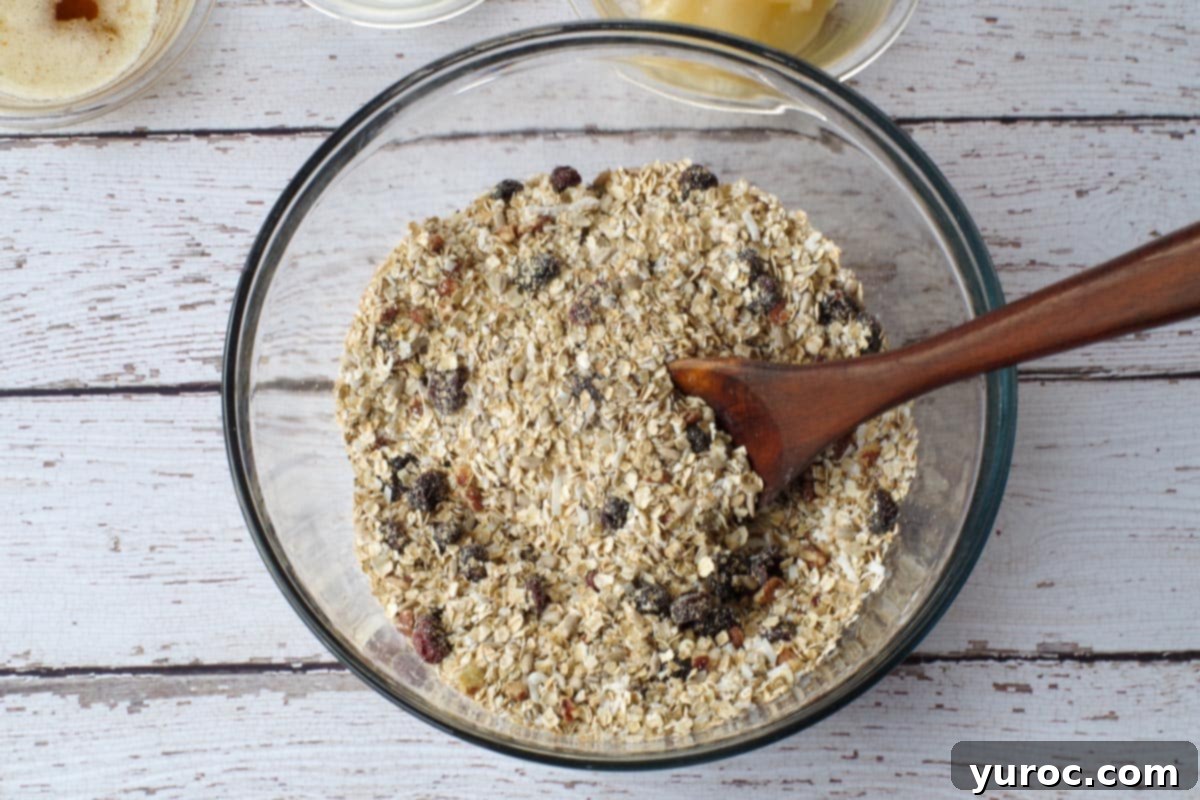 Dry ingredients for brown butter pecan granola in a large glass bowl, ready for mixing.