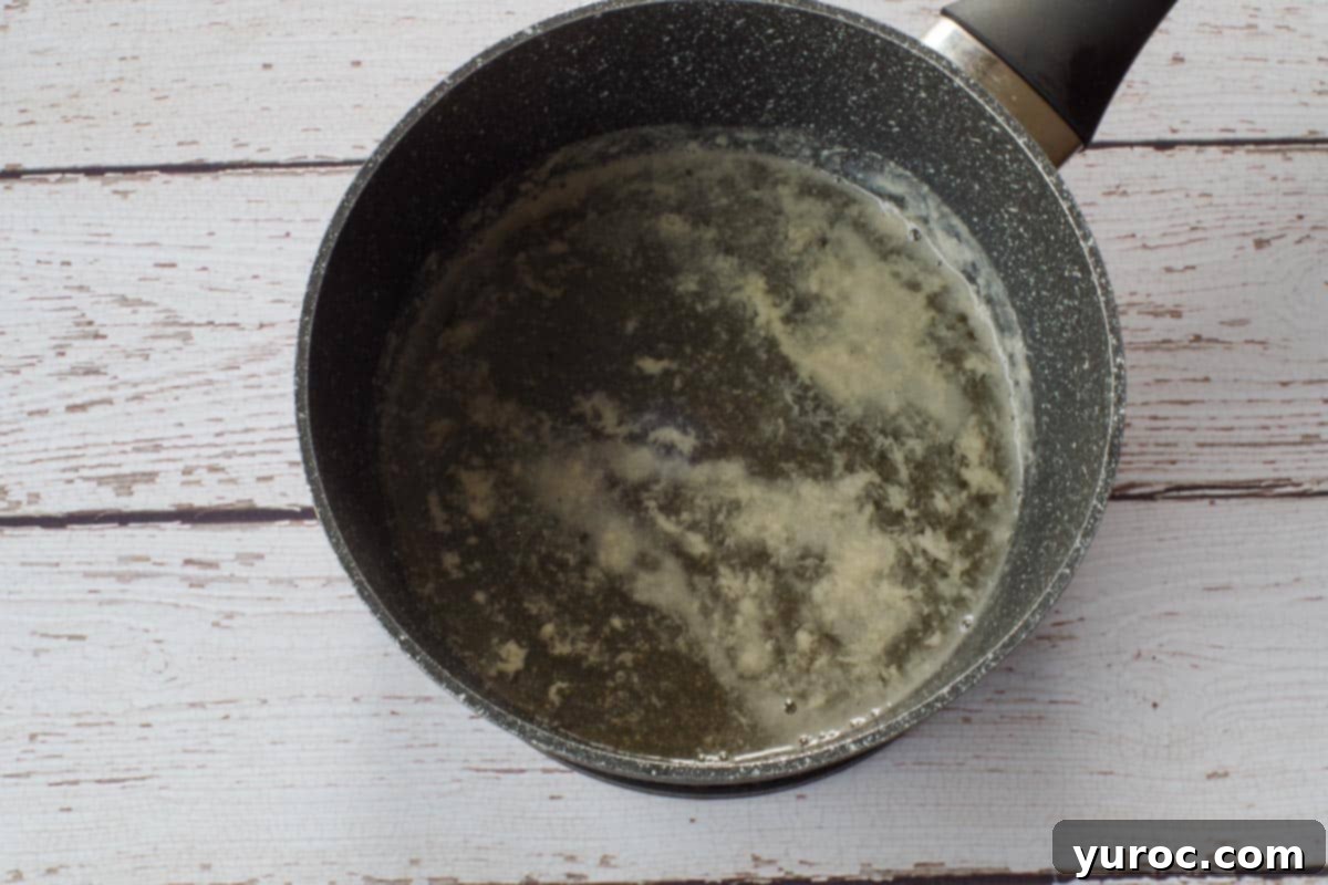 Milk, salt, and honey simmering in a saucepan.