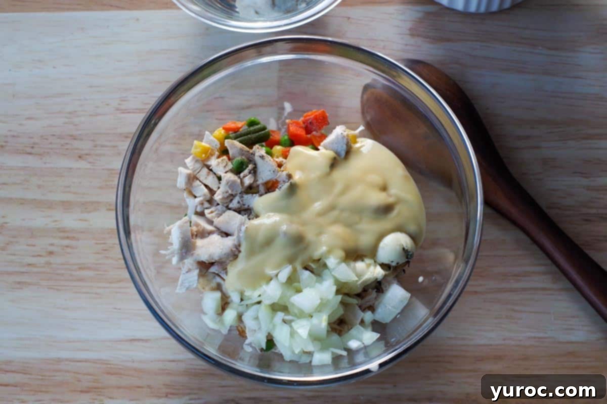 Ingredients in chicken pot pie in a glass bowl