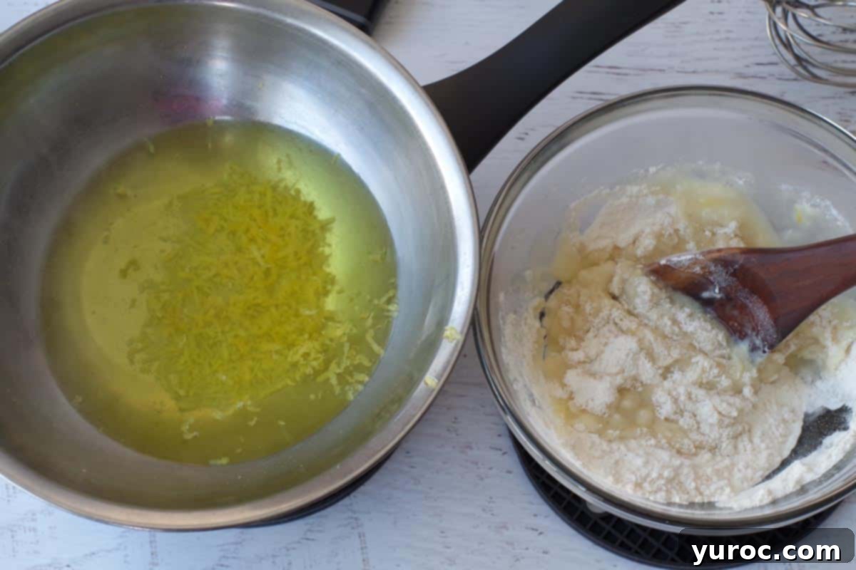 A small amount of the hot lemon water mixture being added to the flour and sugar mixture in a glass bowl.