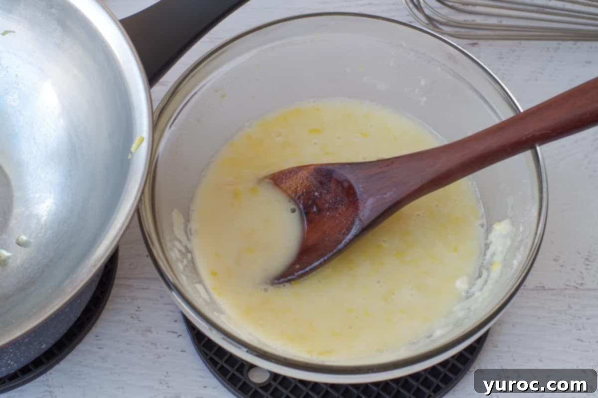 The flour, sugar, and lemon water mixture fully incorporated and mixed together in a glass bowl.