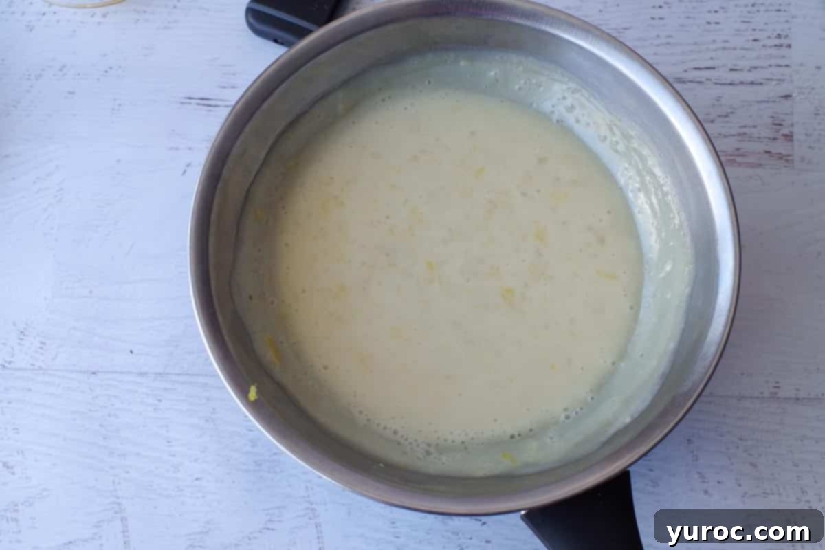 The flour and lemon water mixture thickening over a double boiler on the stove.
