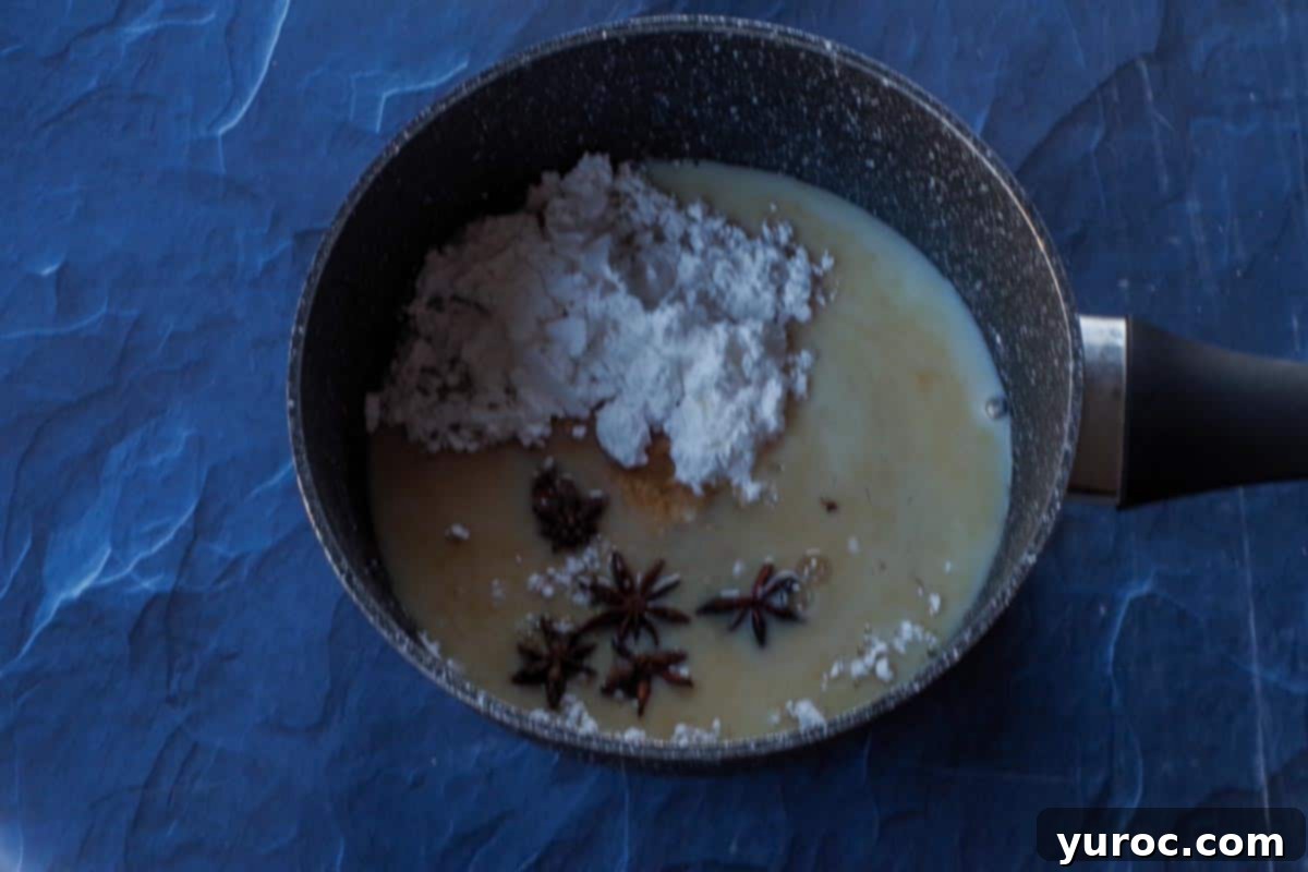 Decadent Salted Soft Butter Toffee 4 Icing sugar, milk, corn syrup, star anise, and vanilla extract are combined in a saucepan, ready to be heated.