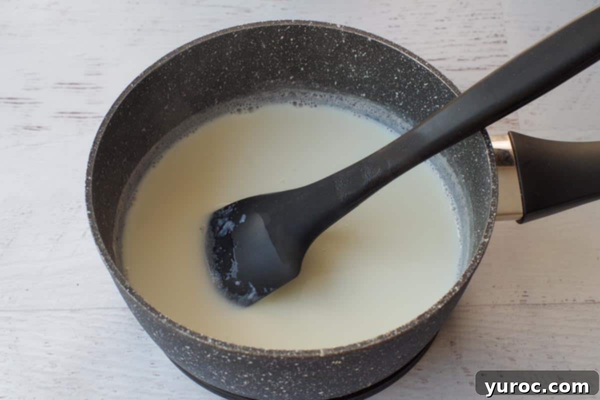 scalded milk in a pot with a black spatula