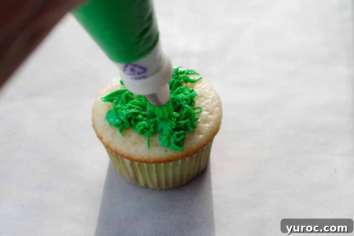 Mini Egg Hunt Cupcake Treasures 10 Cupcakes meticulously covered with piped green frosting, resembling blades of grass.