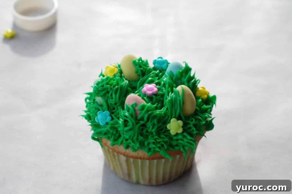 Mini Egg Hunt Cupcake Treasures 14 Cupcakes adorned with delicate candy flowers scattered over the green grass frosting, completing the spring theme.
