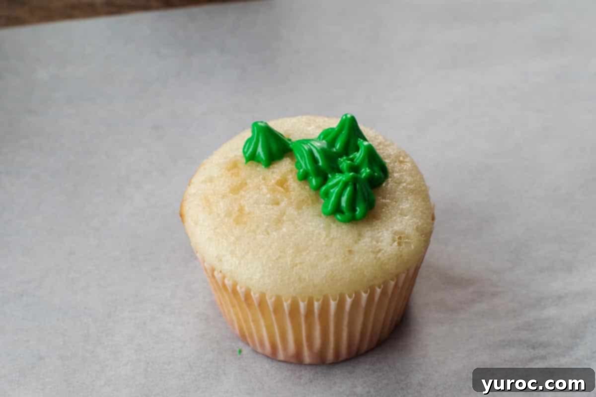 Mini Egg Hunt Cupcake Treasures 16 A cupcake with frosting that appears soft and 'blobby', indicating it's too warm for proper piping.