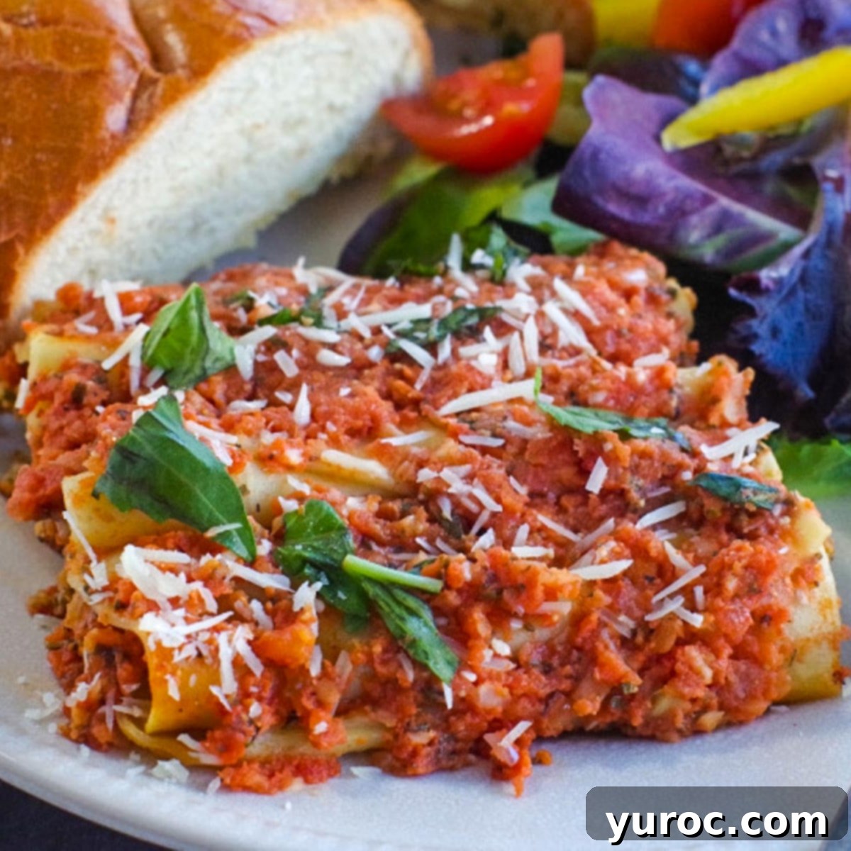 Timeless Chocolate Pie 10 Baked beef cannelloni served on a white plate with a side of salad and garlic toast