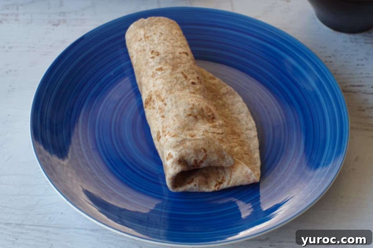 tortilla wrapped up on a blue plate