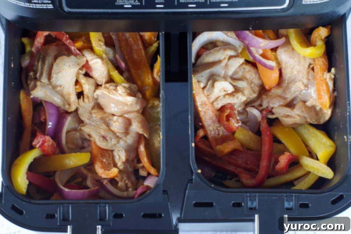 air fryer fajitas in drawers being shaken/stirred at each 5 minute interval