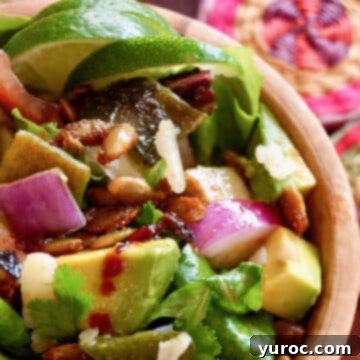 What to Serve with Carnitas: 25 Irresistible Recipes 13 Chopped Mexican salad served in a brown bowl, topped with pepitas.