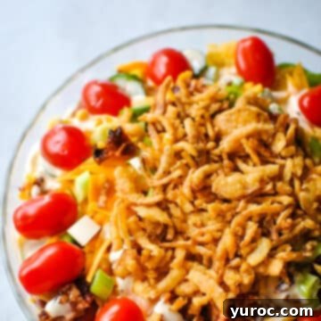 What to Serve with Carnitas: 25 Irresistible Recipes 16 Layered Cornbread Salad in a clear glass bowl, showcasing its distinct ingredients.