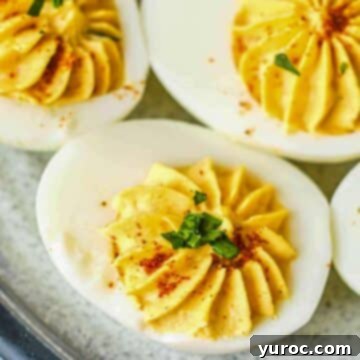 What to Serve with Carnitas: 25 Irresistible Recipes 17 Three Mexican deviled eggs, garnished and arranged on a grey plate.